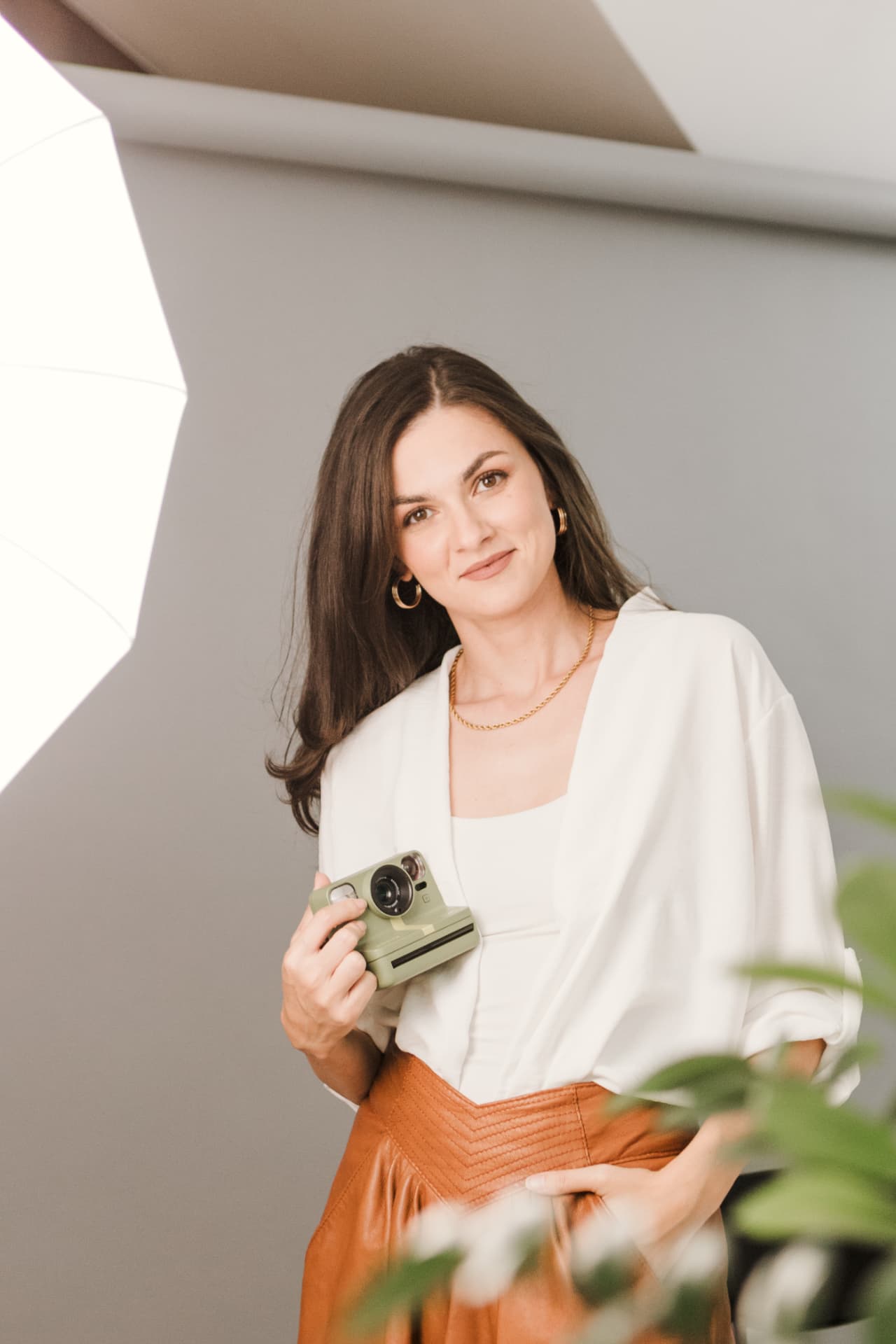 Portrait of Milica Karan holding a Polaroid camera